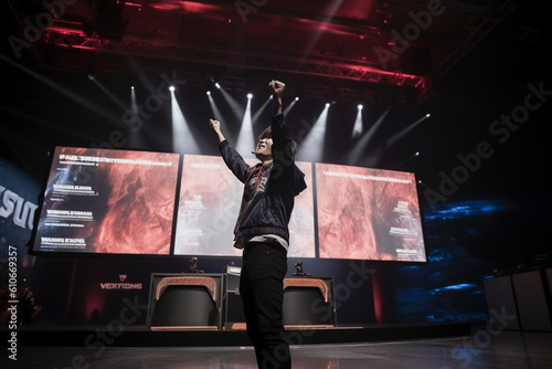 A player standing in front of a large screen displaying the winning message, raising their arms triumphantly Generative AI