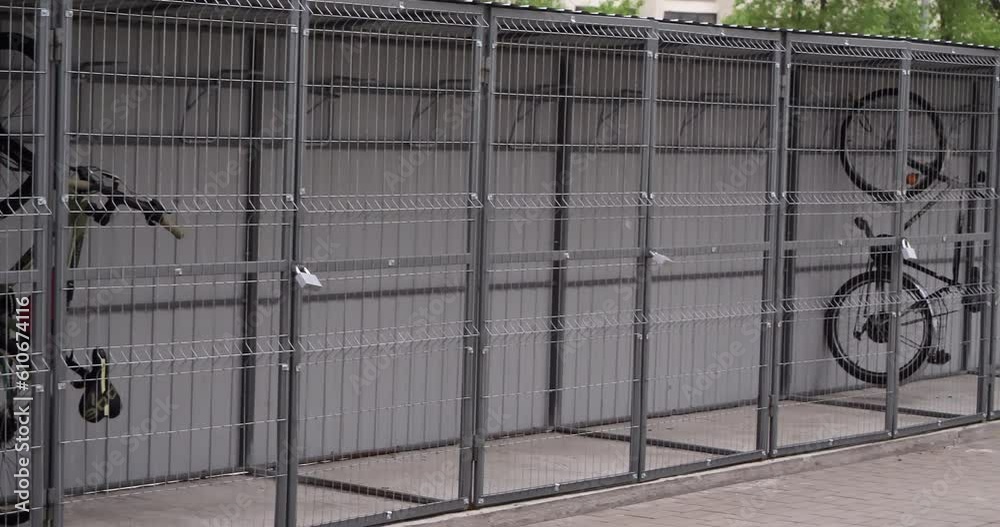 Covered bicycle parking. Enclosed parking with suspended bikes. Metal mesh garage that blows wind from all sides. Bikes suspended vertically. Covered bicycle parking. Enclosed parking with suspended bikes. Metal mesh garage that blows wind from all sides. Bikes suspended vertically.