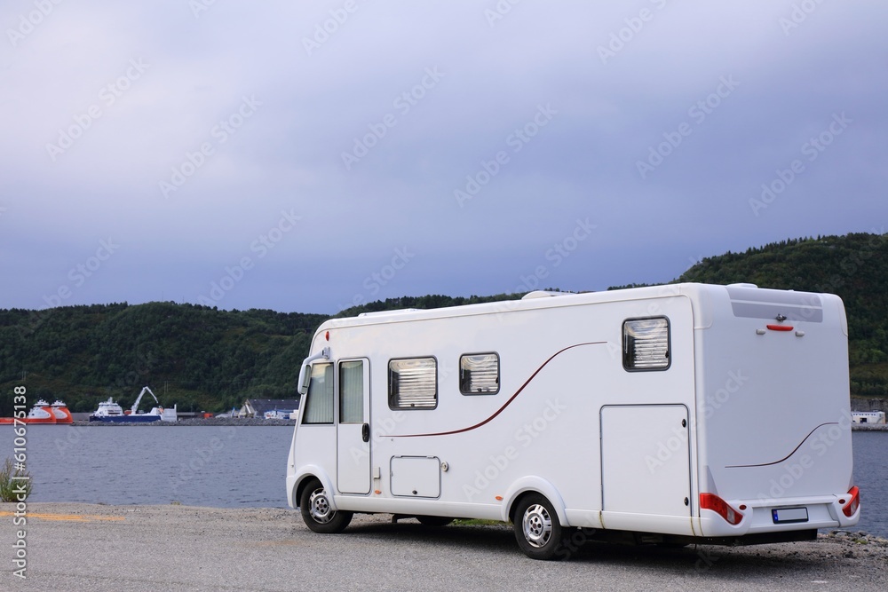 Camper vacation near Alesund, Norway. White camper van recreational vehicle.
