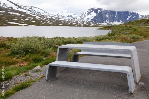 Winter in summer - snow in Norway. Sunnmore Alps picnic table at a rest place. photo