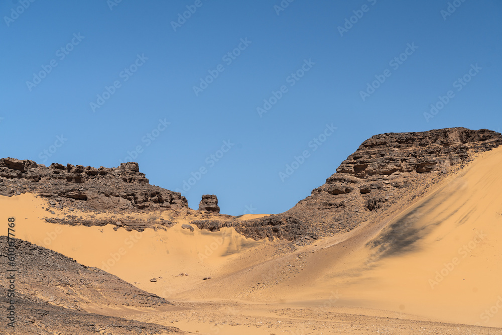 Naklejka premium view in the Sahara desert of Tadrart rouge tassili najer in Djanet City ,Algeria.colorful orange sand, rocky mountains