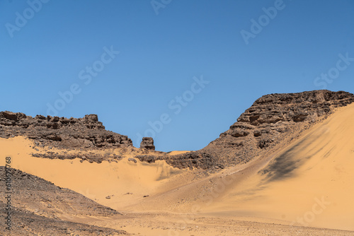 view in the Sahara desert of Tadrart rouge tassili najer in Djanet City ,Algeria.colorful orange sand, rocky mountains