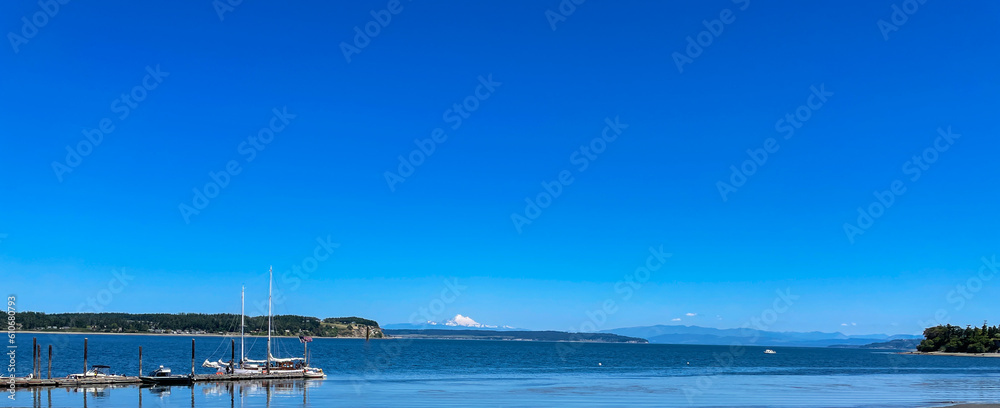 Landscape of Boats Moored to Coupeville Wharf in Penn Cove on Whidbey Island, Washington, USA on a Sunny June Day with Mount Baker in the Background