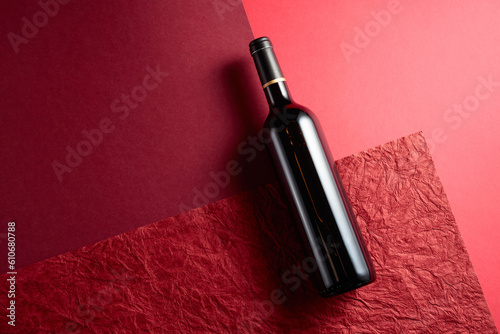 Fototapeta Naklejka Na Ścianę i Meble -  Bottle of red wine on a red background.