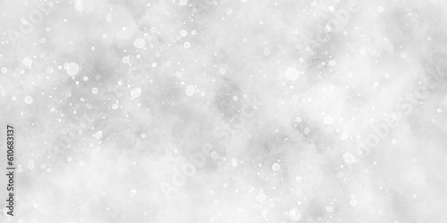 Abstract winter morning shiny white snow is falling randomly with various bokeh particles, beautiful grey watercolor background with glitter particles for wallpaper and design and presentation. © DAIYAN MD TALHA