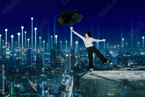 Picture of female entrepreneur flying with an umbrella