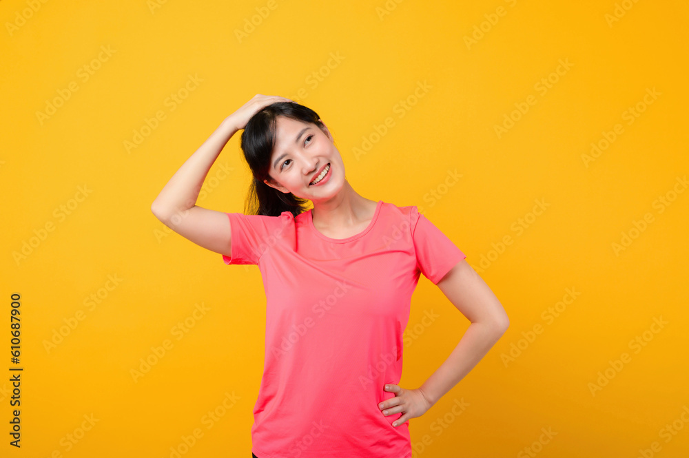 Portrait beautiful young asian sports fitness woman happy smile wearing pink sportswear posing exercise training workout isolated on yellow studio background. wellbeing and healthy lifestyle concept.