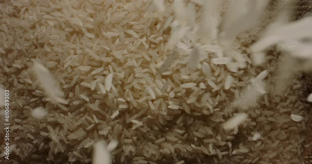 Rice grains fall into an open sack. Top view slow motion camera zoom. Woven rustic food culture crop management nature gunny sackcloth bag Rice grains fall into an open sack. Top view slow motion camera zoom. Woven rustic food culture crop management nature gunny sackcloth bag