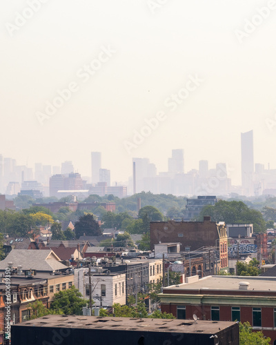 Hazy Toronto skyline with smoke from wildfires creating dangerous air quality and poor visibility. 