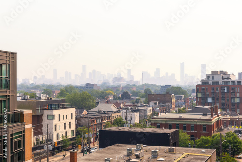 Hazy Toronto skyline with smoke from wildfires creating dangerous air quality and poor visibility. 