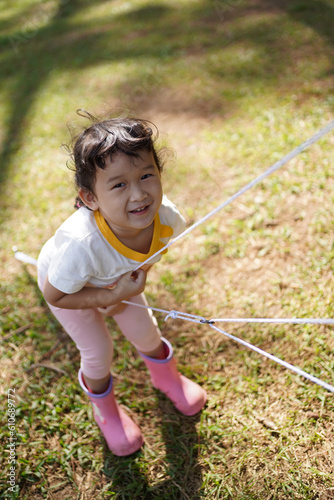 child playing on rope