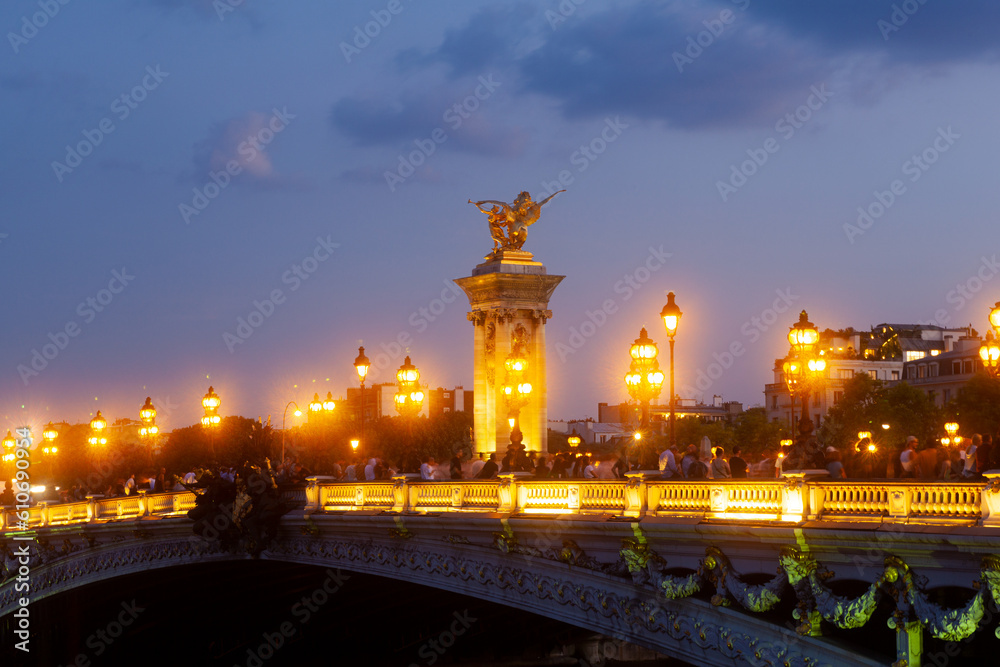Pont Alexandre III Bridge and illuminated lamp posts at sunset. 7th Arrondissement, Paris, France