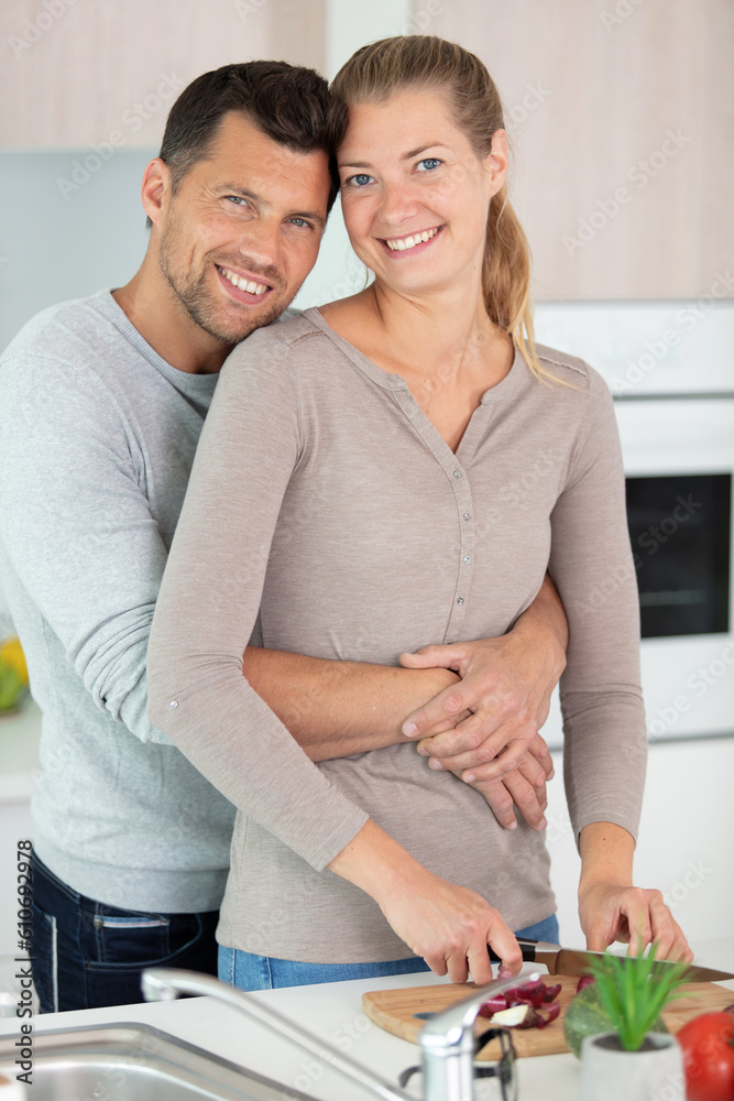 portrait of a cheerful young couple cooking together portrait of a cheerful young couple cooking together