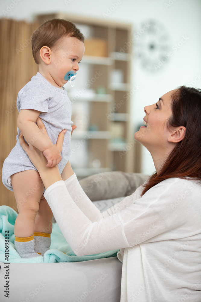 portrait of mother and baby playing and smiling at home portrait of mother and baby playing and smiling at home