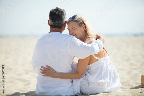 happy romantic middleaged couple in love hugging on the beach
