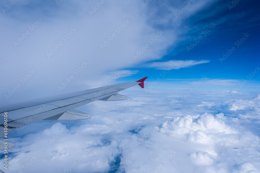 View of the aircraft wing and Earth from the airplane porthole. Travel concept.