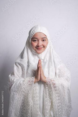 Asian Muslim woman wearing white mukena  while praying