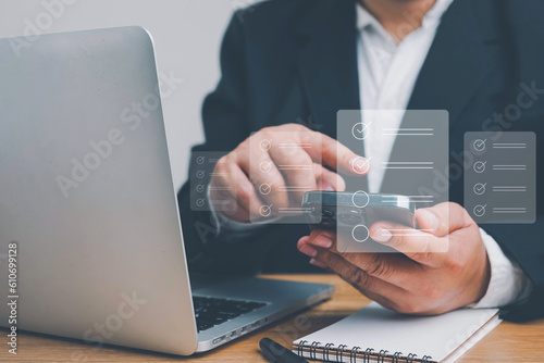 Business performance checklist, Quick checklist and clipboard management concept, job applicants, businessman using laptop doing online checklist survey,Employees must complete the online survey form.