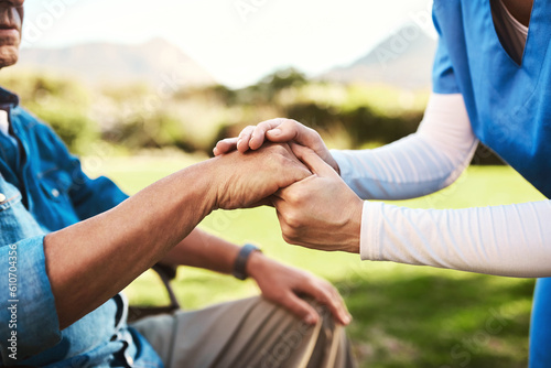 Senior, nurse and holding hands in wheelchair for healthcare support, love or elderly care compassion in nature. Hand of caregiver helping man patient or person with a disability outside nursing home