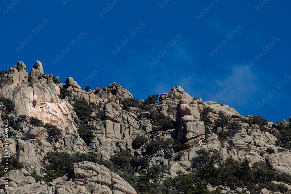 Impresionante paisaje de montañas rocosas en La Pedriza, con el río Manzanares serpenteando entre las formaciones de piedra. 