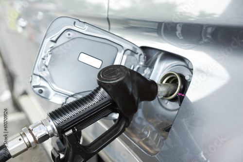 Gas pump nozzle in the fuel tank of a car, Oil and gas Price and demand concept