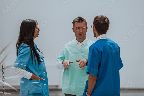 A nurse, medical technician, and doctor engage in a discussion on various medical topics in a modern, high-tech hospital, showcasing teamwork, expertise, and the utilization of advanced technology to photo