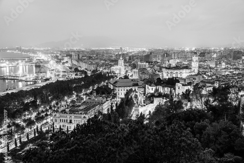 Malaga, Andalusia, Spain: Panoramic aerial view of Malaga coastline, Malaga Cathedral, old town and port at twilight in black and white