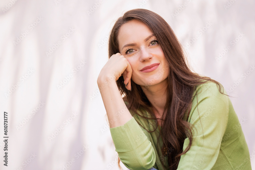 Portrait of young woman with beautiful green eyes and brunette hair posing at sunglight Portrait of young woman with beautiful green eyes and brunette hair posing at sunglight