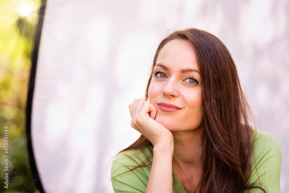 Portrait of young woman with beautiful green eyes and brunette hair posing at sunglight Portrait of young woman with beautiful green eyes and brunette hair posing at sunglight