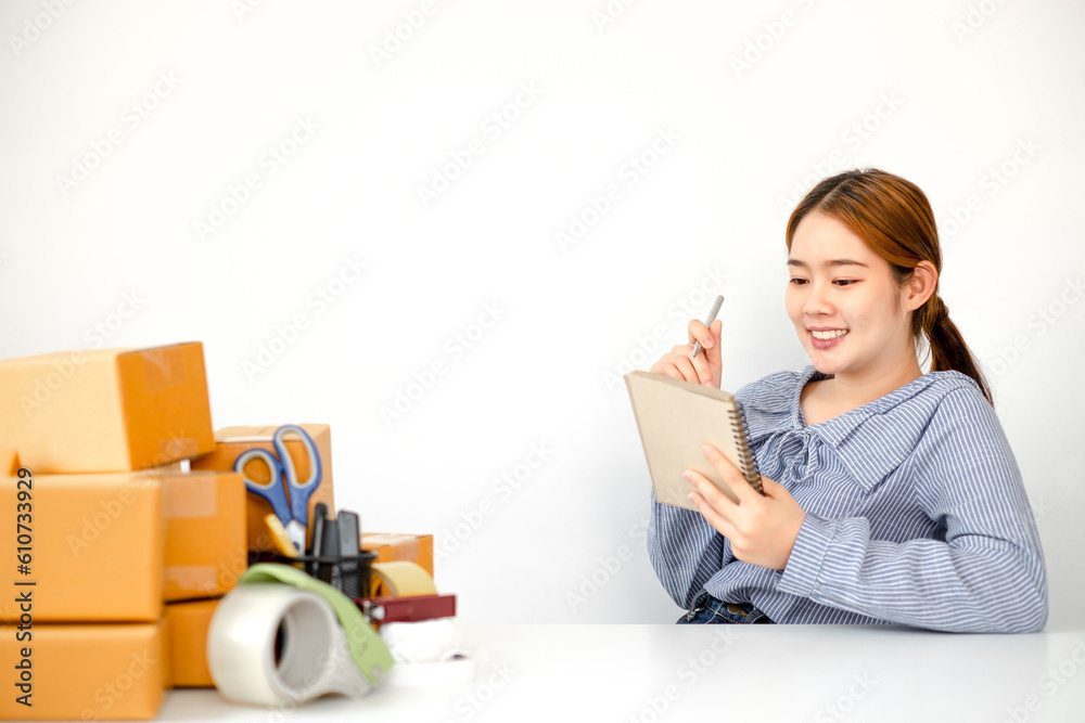 The young woman is diligently checking orders that have been placed since the opening of her online store, ensuring accuracy and preparing for timely fulfillment. The young woman is diligently checking orders that have been placed since the opening of her online store, ensuring accuracy and preparing for timely fulfillment.