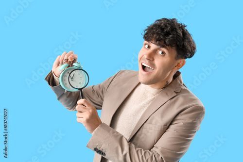 Young man with magnifier an...