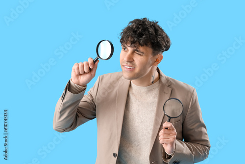 Young man with magnifiers o...