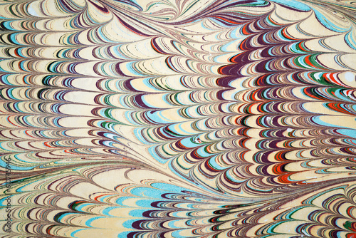 Ebru art. Traditional Turkish Ebru technique. Painting on water, followed by paper prints. Color paint ebru with waves and tile pattern.