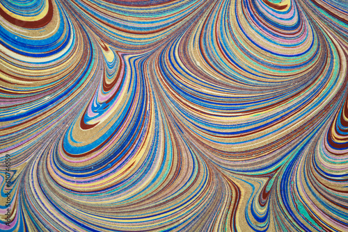 Ebru art. Traditional Turkish Ebru technique. Painting on water, followed by paper prints. Color paint ebru with waves and tile pattern.