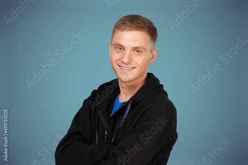 Happy and carefree young man posing in the studio