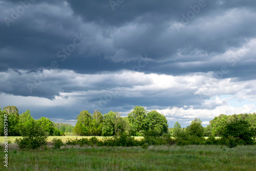 stormy dark clouds over meadows