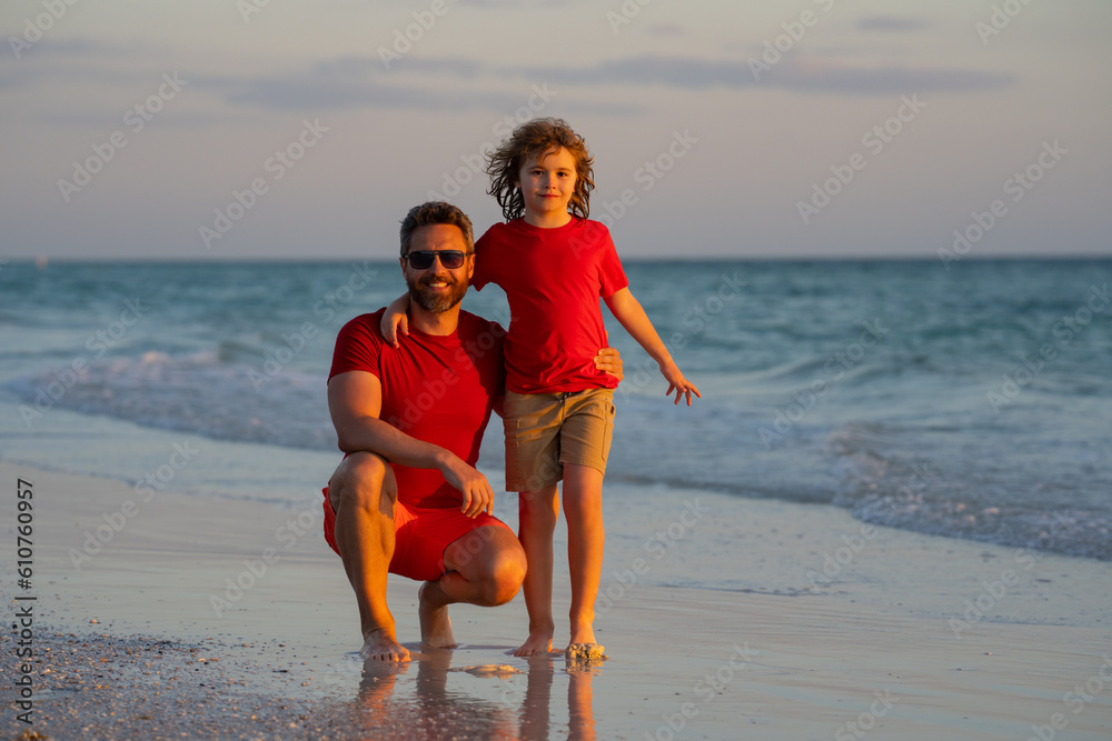 Father and son hugging in sea beach. Concept of friendly family. Happy family on beach, summer holiday vacation. Dad with kid enjoy outdoor lifestyle activity together at the sea. Father and son hugging in sea beach. Concept of friendly family. Happy family on beach, summer holiday vacation. Dad with kid enjoy outdoor lifestyle activity together at the sea.