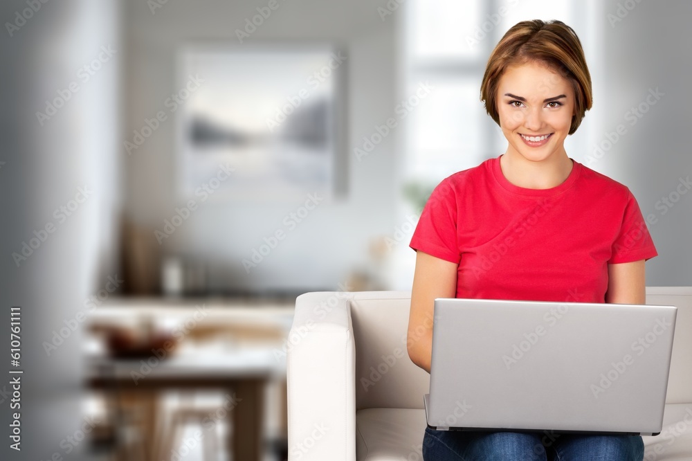 Beautiful happy woman use laptop computer at home