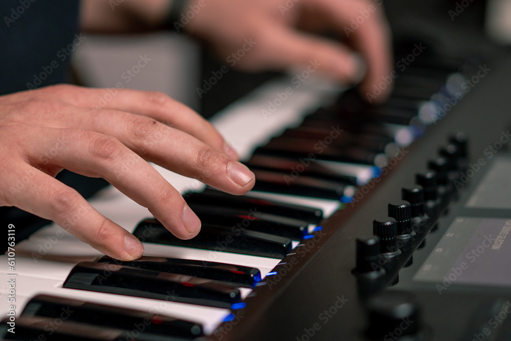 Fototapeta premium professional recording studio sound engineer or music producer musician pressing synthesizer keys