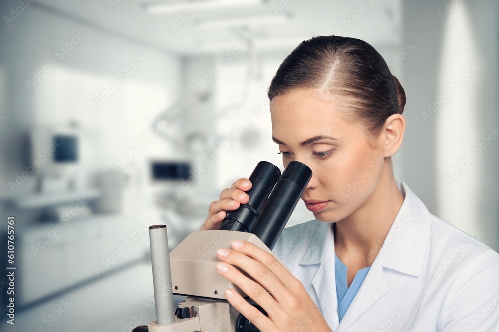 Young smart scientist with a microscope in the laboratory. Young smart scientist with a microscope in the laboratory.