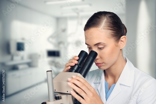 Fototapeta Naklejka Na Ścianę i Meble -  Young smart scientist with a microscope in the laboratory.