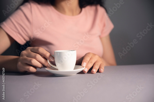 women drink a coffe and siting in phone