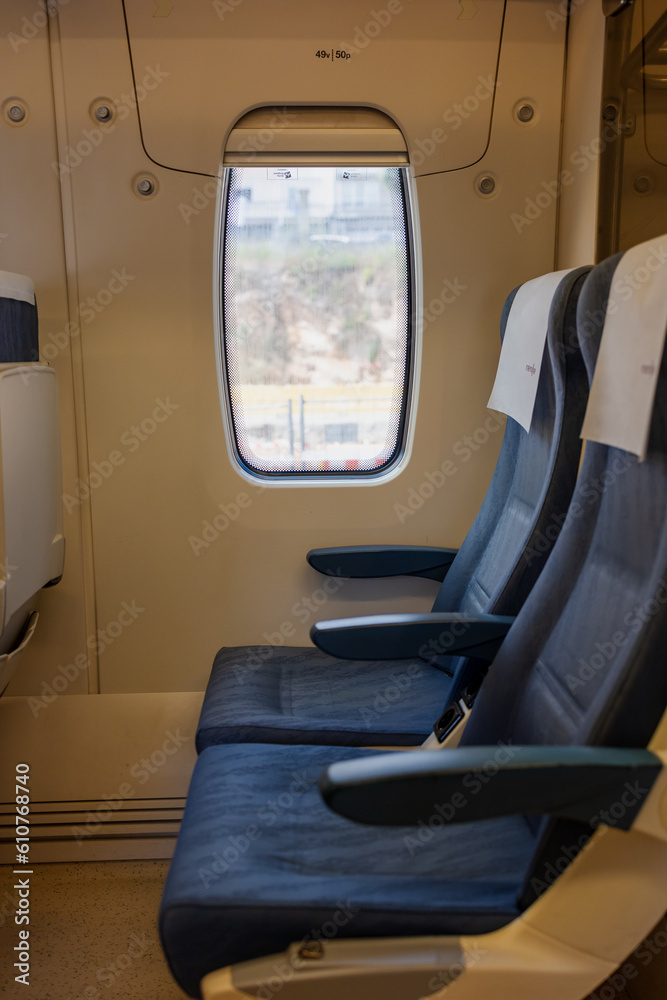 Comfortable seats inside the train without people next to the window