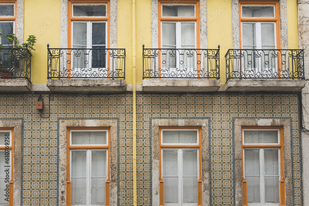 Classic apartment building with balconies and shutters in Lisbon, Portugal