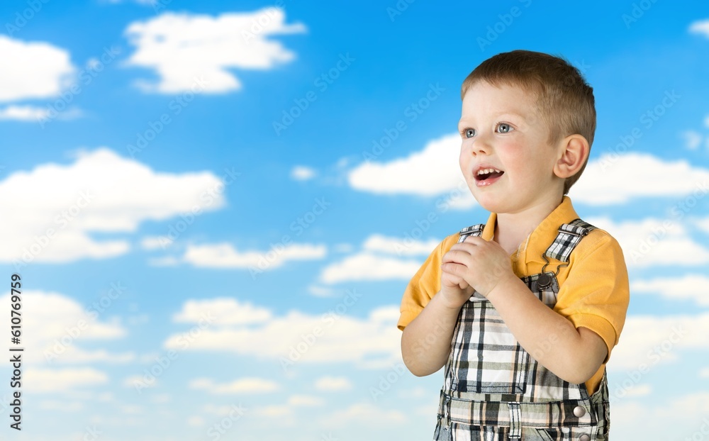 Happy Child standing on blue sky background. Happy Child standing on blue sky background.