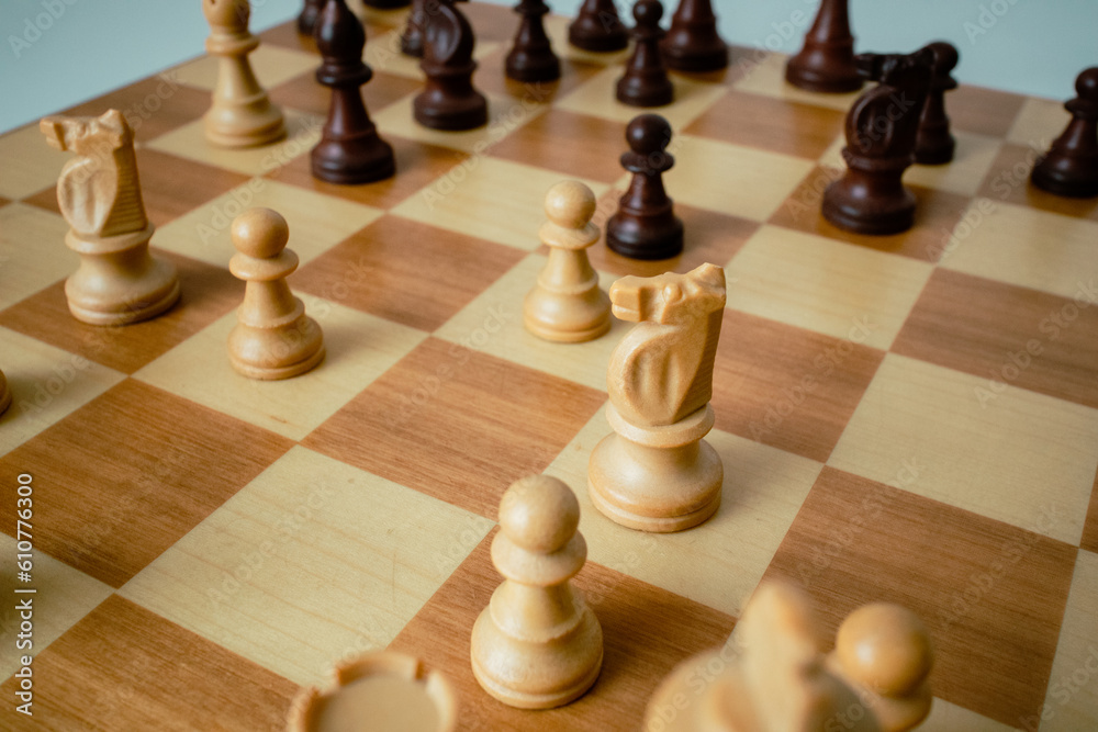 closeup photo of the chess board. Chess board on the round white table. Chess pieces lined up on the board. London System Sicilian defense. Game start closeup photo of the chess board. Chess board on the round white table. Chess pieces lined up on the board. London System Sicilian defense. Game start