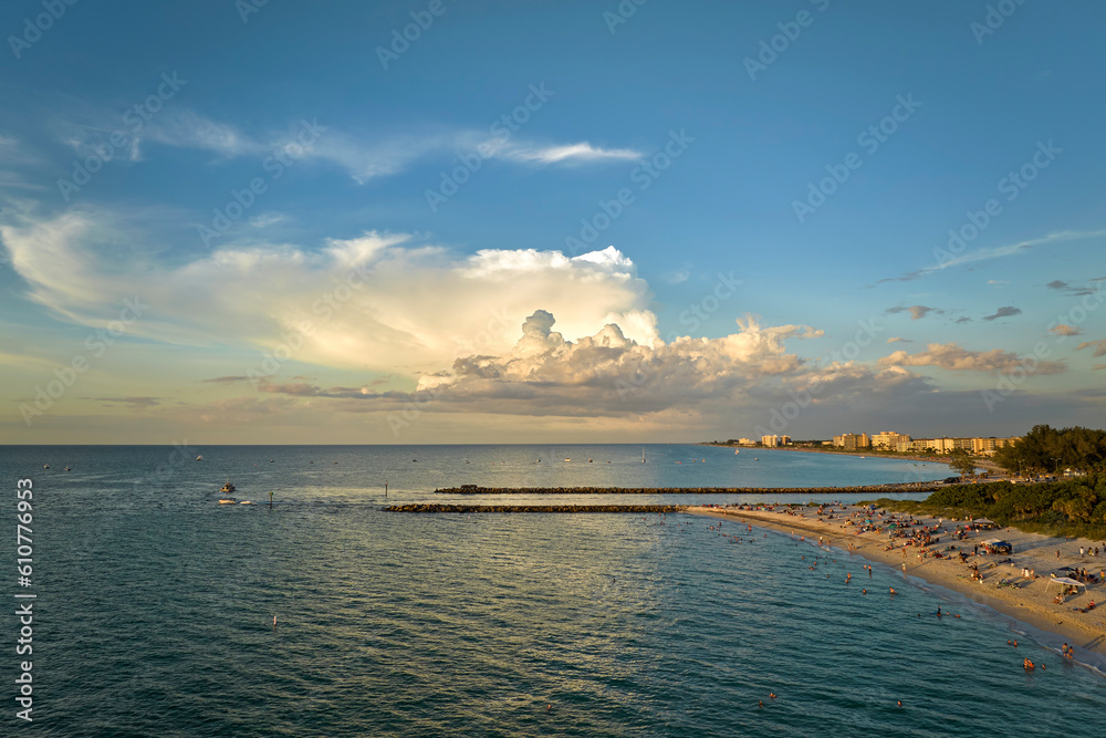 Aerial view of Nokomis beach in Sarasota County, USA. Many people enjoing vacation time swimming in gulf water and relaxing on warm Florida sun at sunset