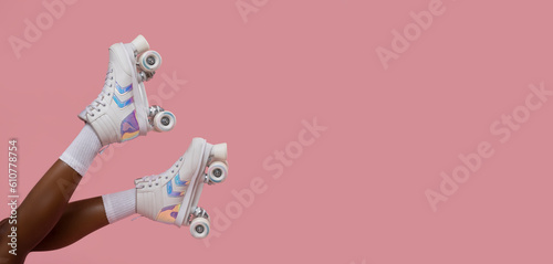 Fototapeta Retro roller skates on female legs.