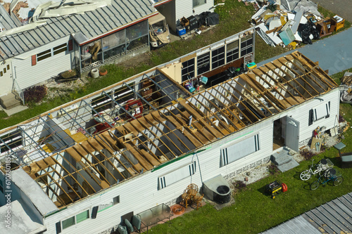 Severely damaged houses after hurricane Ian in Florida mobile home residential area. Consequences of natural disaster photo