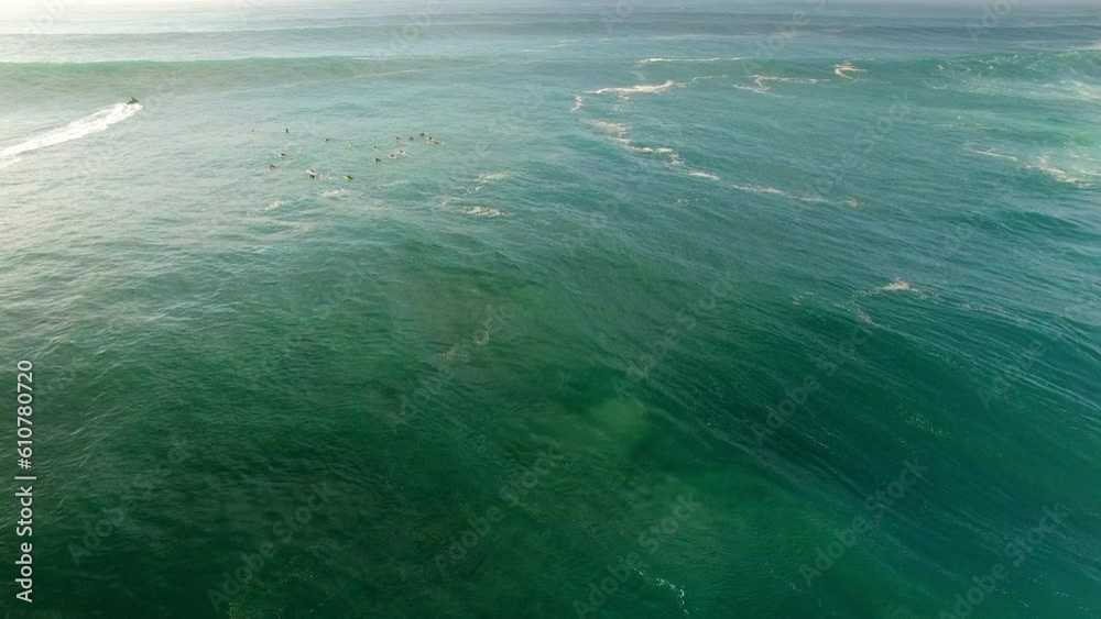 Aerial Lockdown Shot Of Surfers On Sea Waves During Sunset, Drone Flying Over Water - Oahu, Hawaii Aerial Lockdown Shot Of Surfers On Sea Waves During Sunset, Drone Flying Over Water - Oahu, Hawaii